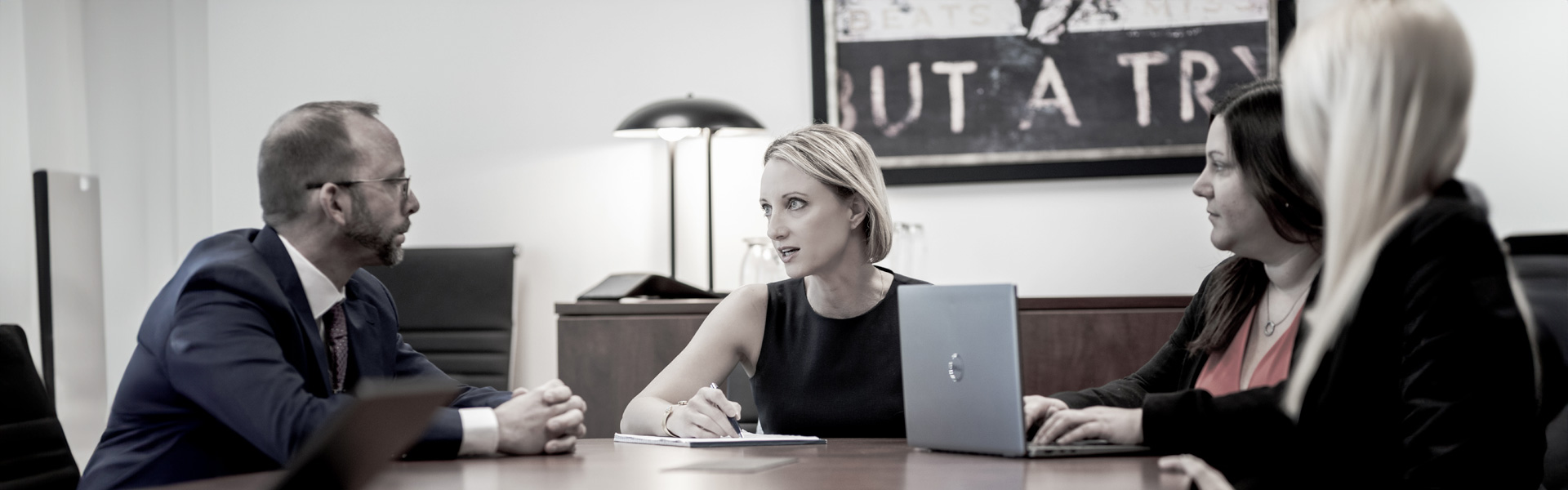 team members gathered at a conference table in discussion