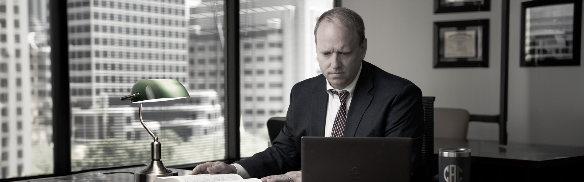 David Ahlheim sits at his desk looking down at a laptop